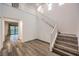 Open foyer view with stairs and wood-look floors flowing into a living space at 12404 Aster Hills Ave, Las Vegas, NV 89138