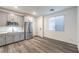 Kitchen featuring stainless steel appliances, modern cabinets, and stylish wood-look floors at 12404 Aster Hills Ave, Las Vegas, NV 89138