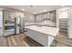 Stylish kitchen featuring stainless steel appliances, a central island, and ample cabinet space at 12404 Aster Hills Ave, Las Vegas, NV 89138