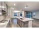Modern kitchen with a large center island, stainless steel appliances, and gray cabinets at 12404 Aster Hills Ave, Las Vegas, NV 89138