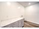 Well-lit laundry room featuring sleek cabinets and modern wood-look floors at 12404 Aster Hills Ave, Las Vegas, NV 89138