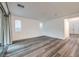 A bare living room with fresh paint, modern lighting, sleek floors, and bright windows at 12404 Aster Hills Ave, Las Vegas, NV 89138