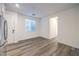 Bright living room features light wood floors, a window, and white walls at 12404 Aster Hills Ave, Las Vegas, NV 89138
