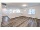 A bright upstairs living room features wood floors and lots of natural light from the many windows at 12404 Aster Hills Ave, Las Vegas, NV 89138