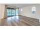 A bare living room with fresh paint, modern sliding glass doors, sleek floors, and bright windows at 12404 Aster Hills Ave, Las Vegas, NV 89138