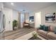 Open-concept living room with desk, couch, hardwood floors and lots of natural light at 12404 Aster Hills Ave, Las Vegas, NV 89138