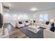 Cozy upstairs living room showcasing modern furniture, plush rug, and ample natural light at 12404 Aster Hills Ave, Las Vegas, NV 89138
