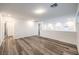 Upstairs living room showing the wood floors, white walls and access to other rooms at 12404 Aster Hills Ave, Las Vegas, NV 89138