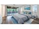 Well-appointed main bedroom with wood flooring, sliding glass doors to the balcony, and neutral decor at 12404 Aster Hills Ave, Las Vegas, NV 89138