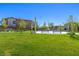 Community park featuring picnic benches, lush green grass, and a clear blue sky at 12404 Aster Hills Ave, Las Vegas, NV 89138