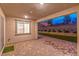 Relaxing outdoor patio showcasing brick floors, a landscaped backyard, and a serene atmosphere at twilight at 12404 Aster Hills Ave, Las Vegas, NV 89138