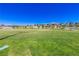 Community soccer field with lush green grass and clear blue sky, surrounded by landscaping and homes at 12404 Aster Hills Ave, Las Vegas, NV 89138