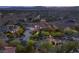 An aerial shot showcases the large property with mature trees, a spacious driveway and a red tile roof at 1383 Opal Valley St, Henderson, NV 89052