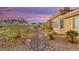 Well-maintained backyard featuring a gravel path, desert landscaping, and privacy at 1383 Opal Valley St, Henderson, NV 89052
