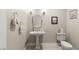 Charming powder room features pedestal sink, decorative mirror, and neutral color palette at 1383 Opal Valley St, Henderson, NV 89052