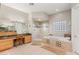 Bright bathroom featuring a double vanity, glass shower, soaking tub, and tiled floors at 1383 Opal Valley St, Henderson, NV 89052