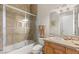 Bathroom featuring a bathtub and glass shower door and a light brown vanity at 1383 Opal Valley St, Henderson, NV 89052