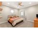 Comfortable bedroom featuring a ceiling fan, octagon window, and neutral color scheme at 1383 Opal Valley St, Henderson, NV 89052