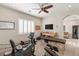Versatile bonus room with gym equipment, comfortable seating, and ample natural light at 1383 Opal Valley St, Henderson, NV 89052