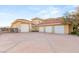 Wide driveway leading to a home with a three-car garage and desert landscaping at 1383 Opal Valley St, Henderson, NV 89052