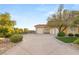 Wide driveway leading to a home with a two-car garage, desert landscaping, and gated entrance at 1383 Opal Valley St, Henderson, NV 89052