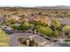 Beautiful two-story home featuring a circular driveway, mature trees, and manicured landscaping at 1383 Opal Valley St, Henderson, NV 89052