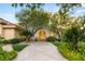 Inviting home exterior featuring mature trees, a stone walkway, and a beautiful wooden front door at 1383 Opal Valley St, Henderson, NV 89052