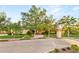 Attractive home exterior with a well-maintained lawn, mature trees, and colorful landscaping at 1383 Opal Valley St, Henderson, NV 89052