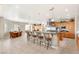 Open-concept kitchen and dining area with barstool seating and stainless appliances at 1383 Opal Valley St, Henderson, NV 89052