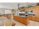 Spacious kitchen with wood cabinetry, granite countertops, and stainless steel appliances at 1383 Opal Valley St, Henderson, NV 89052