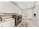 Bright laundry room with washer, dryer, ample cabinet storage, and countertops at 1383 Opal Valley St, Henderson, NV 89052