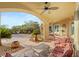 Comfortable outdoor patio with ceiling fans, seating and view of the landscaped backyard at 1383 Opal Valley St, Henderson, NV 89052