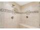 Luxurious shower with dual fixtures, elegant tile work and a built-in bench at 1383 Opal Valley St, Henderson, NV 89052