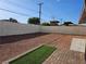 Backyard with gravel, brick patio, and artificial grass at 1720 Eastwood Dr, Las Vegas, NV 89104