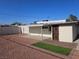 Backyard features gravel ground cover, an artificial turf section, covered patio, and gated access to the house at 1720 Eastwood Dr, Las Vegas, NV 89104