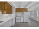 Bright kitchen features white appliances, wood cabinets, subway tile, and wood-look flooring at 1720 Eastwood Dr, Las Vegas, NV 89104
