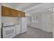 Well-lit kitchen featuring white appliances, wood cabinets, subway tile, and wood-look flooring at 1720 Eastwood Dr, Las Vegas, NV 89104