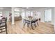Open-concept area with dining, living, and kitchen spaces, featuring wood-look flooring at 1731 Sherwin Ln, Las Vegas, NV 89156