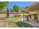 Landscaped backyard featuring a covered patio, swimming pool, and well-maintained lawn at 1905 Dakota Hills Ave, Las Vegas, NV 89123