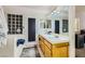 This bathroom showcases a dual sink vanity and natural light from a block window over the bath at 1905 Dakota Hills Ave, Las Vegas, NV 89123