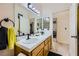 Bright bathroom with a double sink vanity featuring modern lighting, tiled countertops and neutral colors at 1905 Dakota Hills Ave, Las Vegas, NV 89123