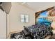 Bedroom with a unique mural, plush rug, ceiling fan and bright natural light at 1905 Dakota Hills Ave, Las Vegas, NV 89123