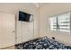 Bedroom featuring light walls, carpet, a ceiling fan and TV at 1905 Dakota Hills Ave, Las Vegas, NV 89123