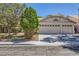 Charming single-story home featuring a three-car garage and mature trees providing shade at 1905 Dakota Hills Ave, Las Vegas, NV 89123