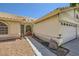 A house showcasing a well-maintained yard, a three-car garage, and detailed architectural features at 1905 Dakota Hills Ave, Las Vegas, NV 89123