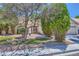 Front yard of a single-story home with lush landscaping and a cozy outdoor seating area at 1905 Dakota Hills Ave, Las Vegas, NV 89123