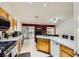 Open kitchen with island, tile countertops, gas range, and easy access to the backyard at 1905 Dakota Hills Ave, Las Vegas, NV 89123