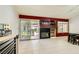 Open concept kitchen with a slider going to a patio and dark fireplace at 1905 Dakota Hills Ave, Las Vegas, NV 89123