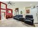 Comfortable living room featuring a leather sofa, accent chair, and neutral carpeting at 1905 Dakota Hills Ave, Las Vegas, NV 89123