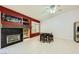A cozy living room featuring a fireplace, tiled floors, and backyard views at 1905 Dakota Hills Ave, Las Vegas, NV 89123